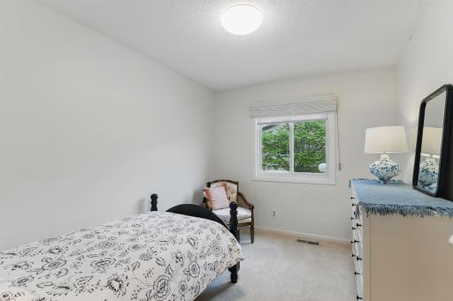 Another angle of the second bedroom, featuring a new window that brings in great natural light.