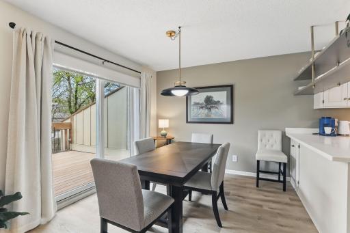 Dining area with newer LVP flooring and easy access to the large deckâgreat for indoor-outdoor living.