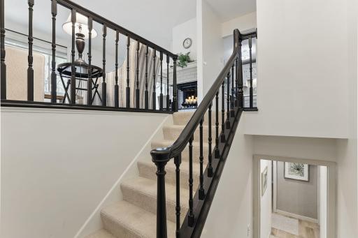 Freshly painted staircase to the walkout lower levelâclean and welcoming transition to additional living space.