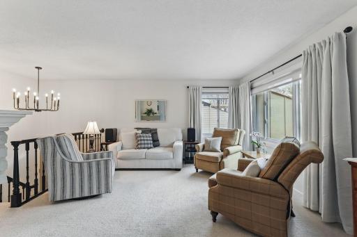 Freshly painted living room with new carpet and crisp white trim for a clean, updated feel.