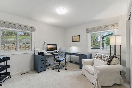 Another view of the third bedroom/home office showcasing natural light and functional space.