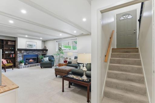 Welcoming lower-level family room with large lookout windows that fill the space with natural light.