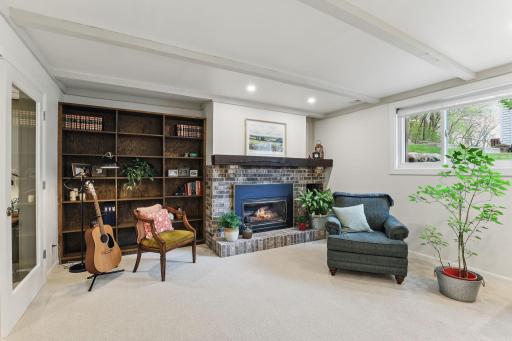 Cozy gas fireplace with built-in bookshelves adds warmth and character to the lower-level family room.