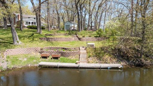 Lakefront and a large lot! Nearly half an acre of mostly level land featuring elegantly tiered, gradual steps that lead down to a private dock and serene shoreline.