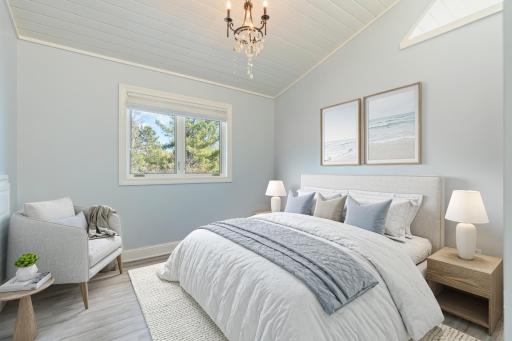 Serene guest bedroom with vaulted ceilings and peaceful views.