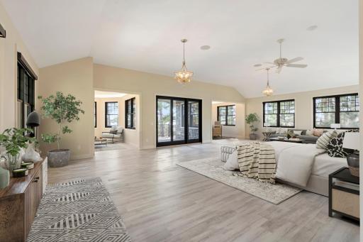 Primary suite with vaulted ceilings, sitting rooms and private deck overlooking the lake.