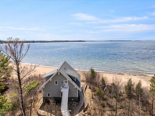 Take the stairs to the upper level of the beach house or continue on the path to the lake!