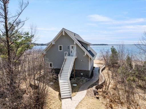 Take the stairs to the upper level of the beach house or continue on the path to the lake!
