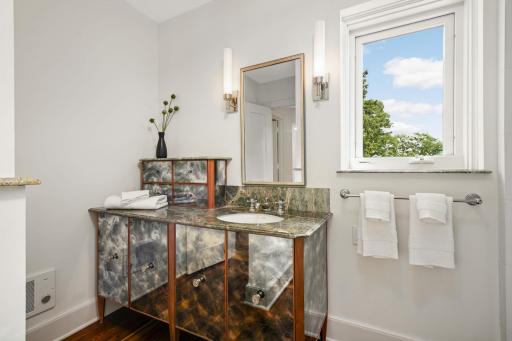 A remodeled full bath adjacent to the primary BR has a whimsical feel and views to the lake