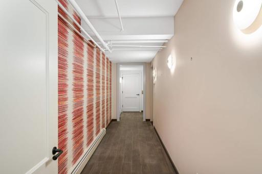 A hallway to the elevator and like new, double attached garage in the lower level