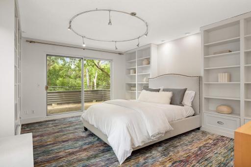 The 4th bedroom has walls of bookcases and a large slider to another large deck
