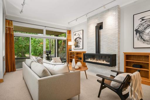 The dramatic main floor family room off the kitchen with a remarkable gas fireplace