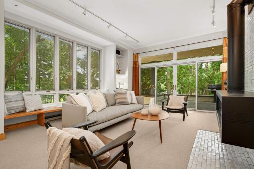 High ceilings and 2 walls of south and west facing glass fill this room with light