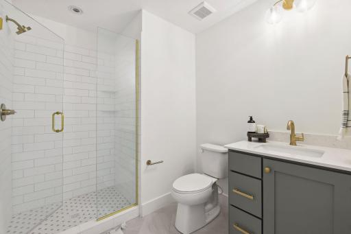 The 3/4 private bath features a classic subway tiled shower with glass enclosure and a comfort-height vanity topped with quartz.