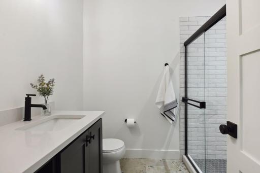 The 3/4 bathroom completes the lower level, featuring heated tile floors for added comfort.