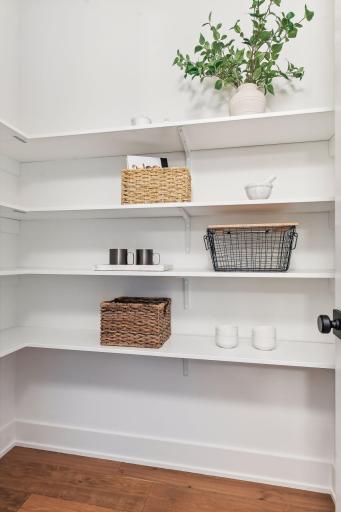 Tucked just off the kitchen, this walk-in pantry offers plenty of storage and easy access to everyday essentialsâkeeping everything organized and within reach.