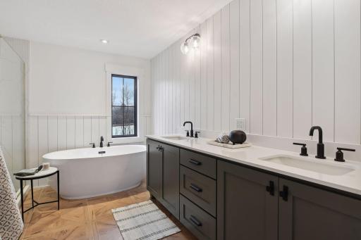The Primary Bath features heated tile floors, a comfort-height vanity topped with quartz, and a soaking tub thatâs made for long, relaxing soaks.