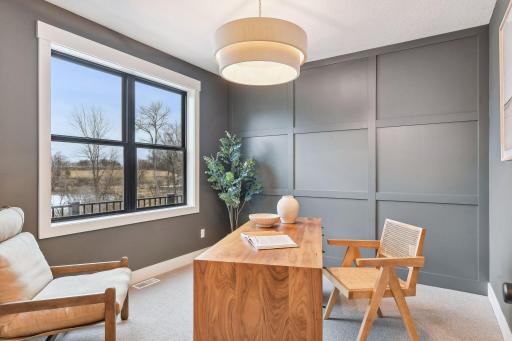 This Home Office combines focus and serenity, featuring glass French doors and peaceful pond views that make working from home feel a little more relaxing.