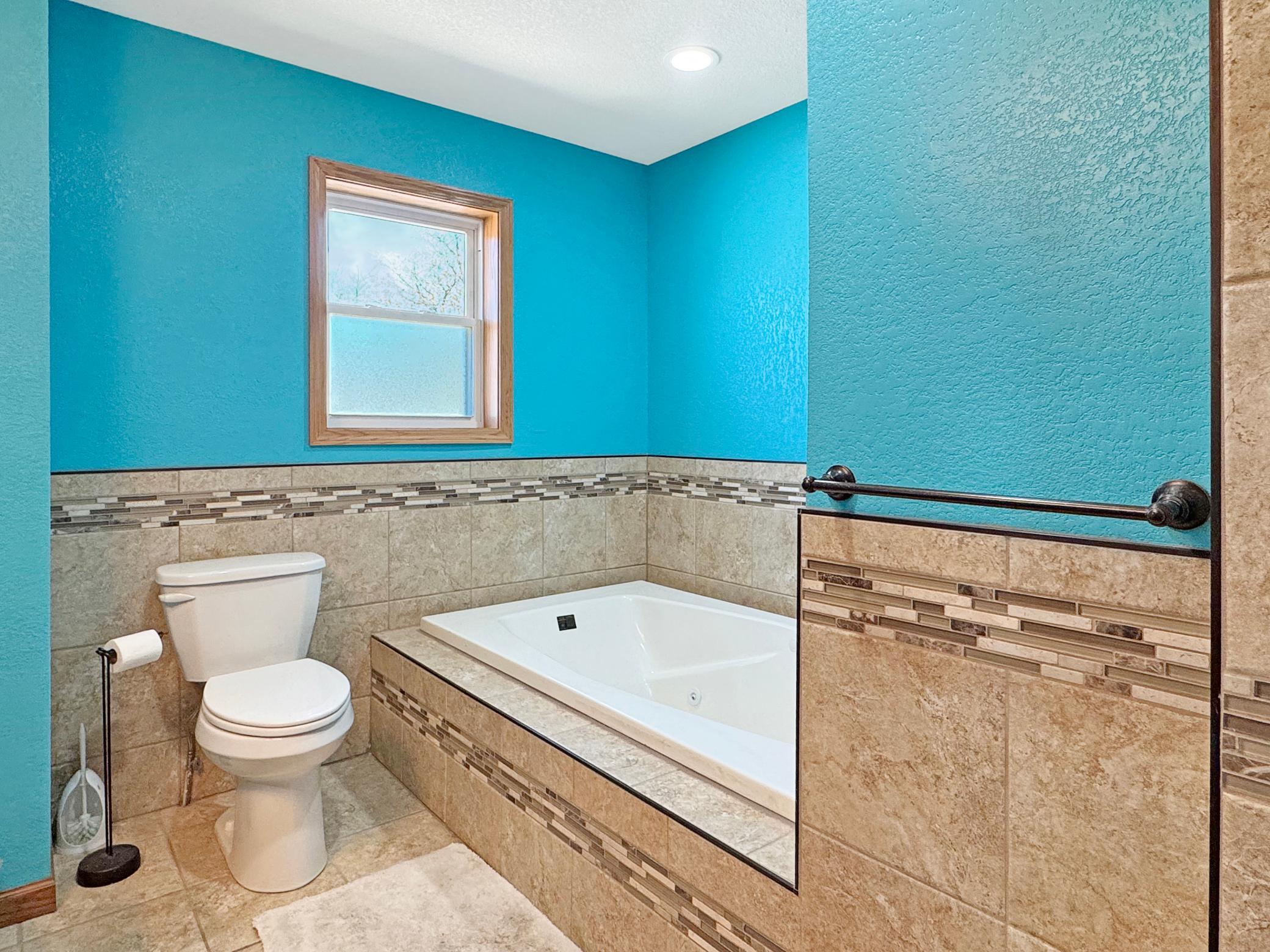 Featuring soaking tub and tile shower