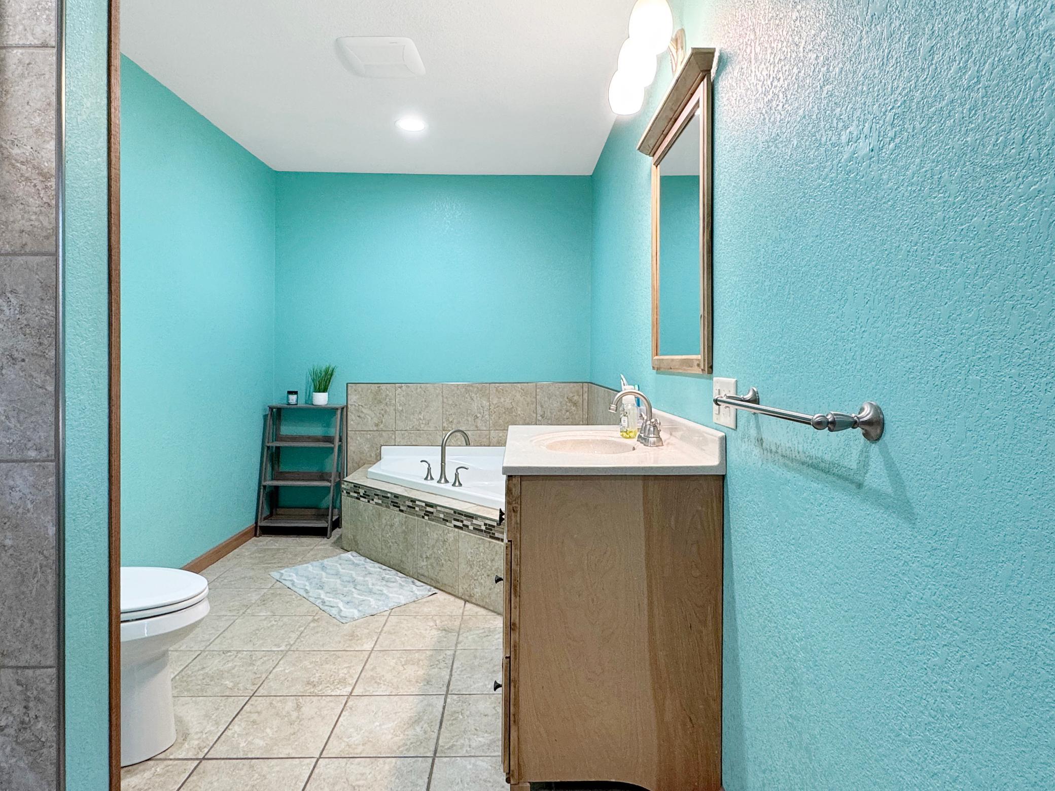 Main floor bathroom also features a tile shower