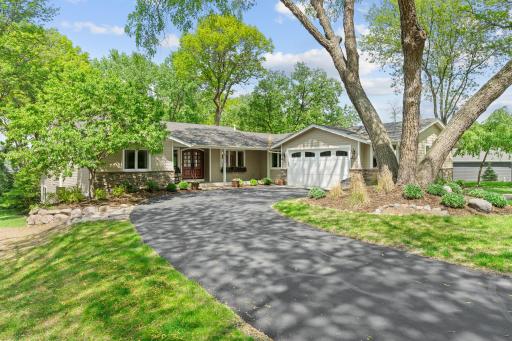 Set on demand level lot with 111 feet of shoreline, this home makes lakeside living feel effortless.
