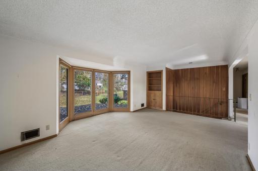 Living Room with floor to ceiling windows viewing the backyard and entrance onto the deck
