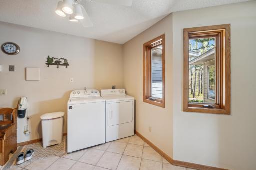 Spacious laundry room with washer/dryer and tile floors
