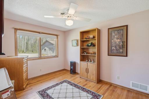 3rd bedroom with hardwood floors and peaceful wooded views