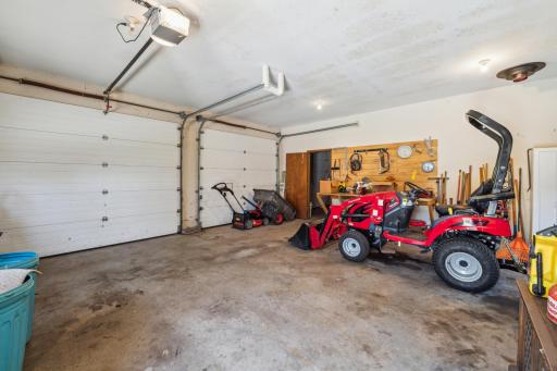 Oversized attached garage with space for vehicles and equipment