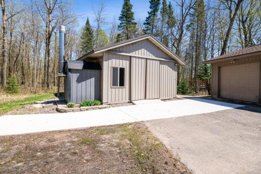 Heated outbuilding with wood-burning boiler and wood storage