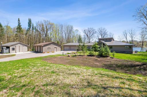 Expansive front yard showcasing the ample attached and detached parking provided