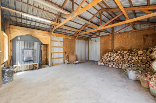 Heated outbuilding with wood-burning boiler and wood storage