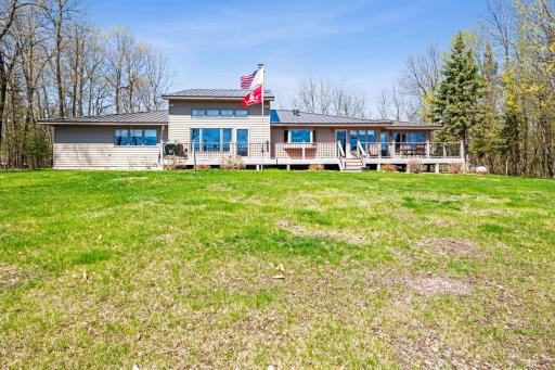 Spacious backyard and expansive deck offering stunning views of the lake, perfect for entertaining or relaxing in nature.