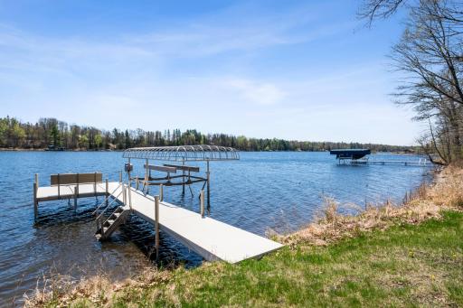 Enjoy direct water access with a private dock featuring a boat lift and built-in bench seating for lakeside enjoyment.