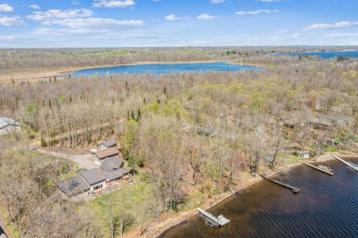 Serene lot nestled along Long Lake, surrounded by mature trees with 200 feet of shoreline