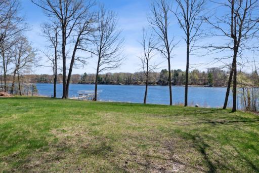 Serene lake views framed by tall trees and open green spaceâideal for peaceful mornings and evening sunsets.