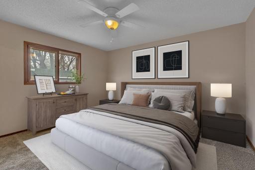 Main level primary bedroom (digitally staged)