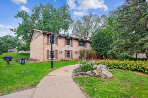 Main level living with green space and landscaped paths.