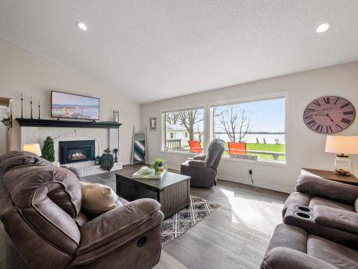 The spacious living area is centered around a cozy fireplace, creating a warm and inviting atmosphere.