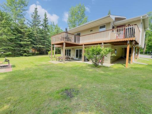 Massive wrap around deck hovers over the patio