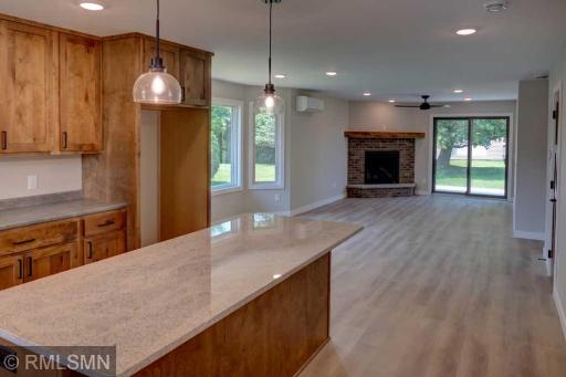 Bright and beautiful kitchen features birch cabinets and a granite island.