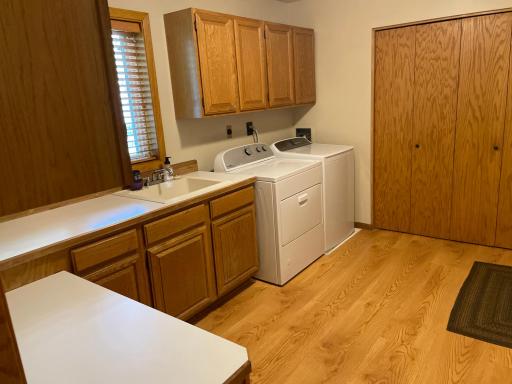 12x9 main floor laundry. Has sink, cabinets, folding table, and a spot for 2nd refrigerator or upright freezer.
