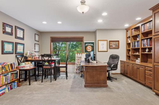 The upper level office features built in cabinets and bookshelves and has a gas fireplace.