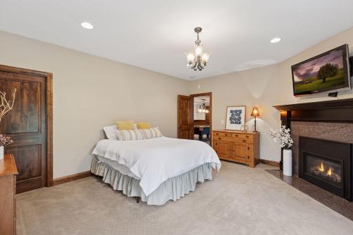 The 5th bedroom or guest suite features a walkout to a patio and a fireplace.