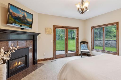 The 5th bedroom or guest suite features a walkout to a patio and a fireplace.