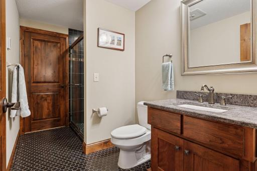 The attached 3/4 bathroom features heated floors and walks into an oversized closet.