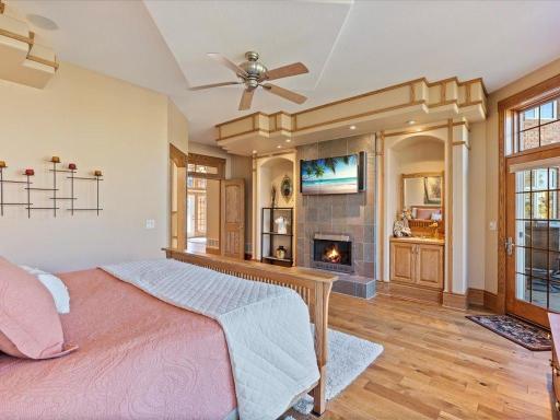 Main Level Primary Bedroom w/ Walk out to Main Level Lakeside Patio.