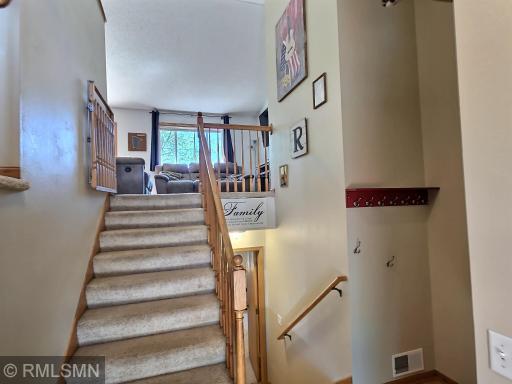 Enter in to find a two-story greeting with extra space for jackets, bags and more on the wall hooks and closet.