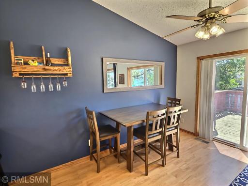 The appealing and low maintenance laminate floors stretch through the dining into the kitchen and make for a simple transition to the deck.
