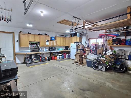 The wonderful garage is heated and offers great storage in the many cabinets and work bench.